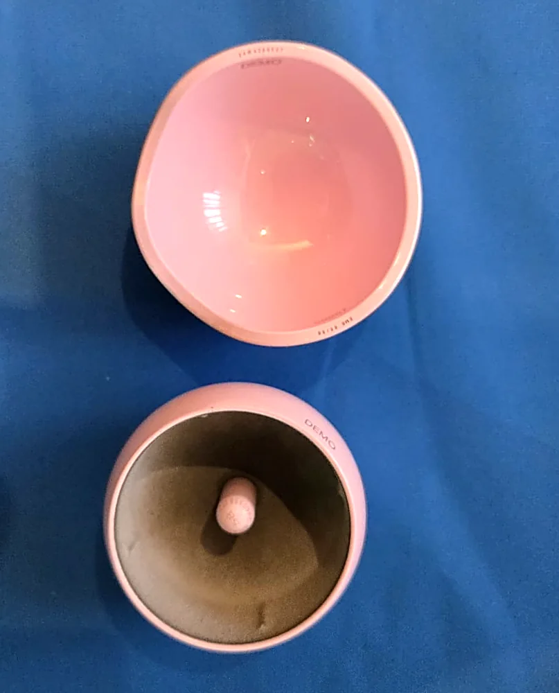 A demonstration set of the H1 ceramic hip resurfacing implant, showing the acetabular cup and femoral resurfacing cap