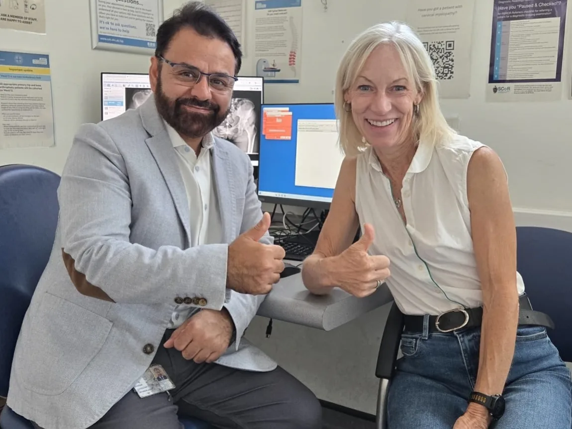 Paula and Mr Shakir Hussain giving a thumbs up in clinic