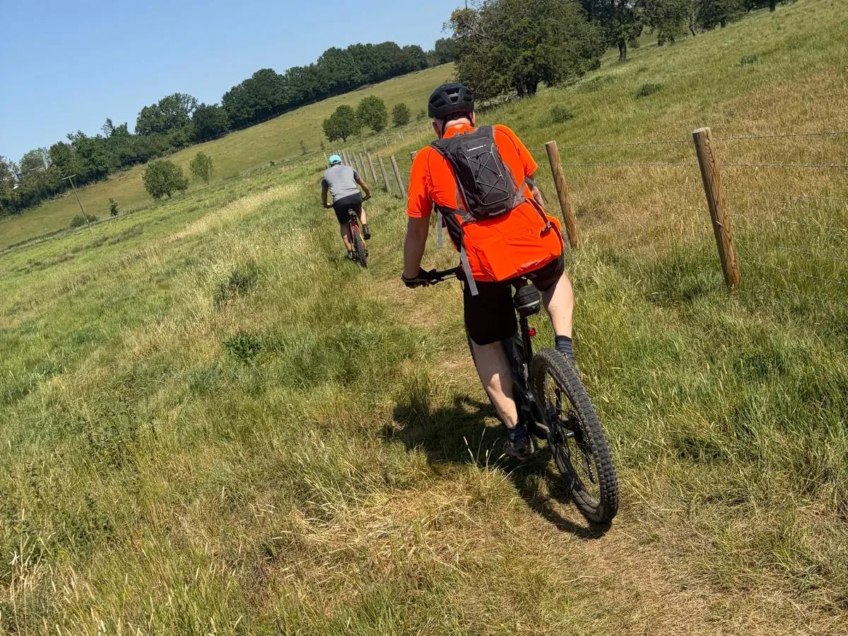 Young adult mountain biking on a woodland trail after hip resurfacing surgery