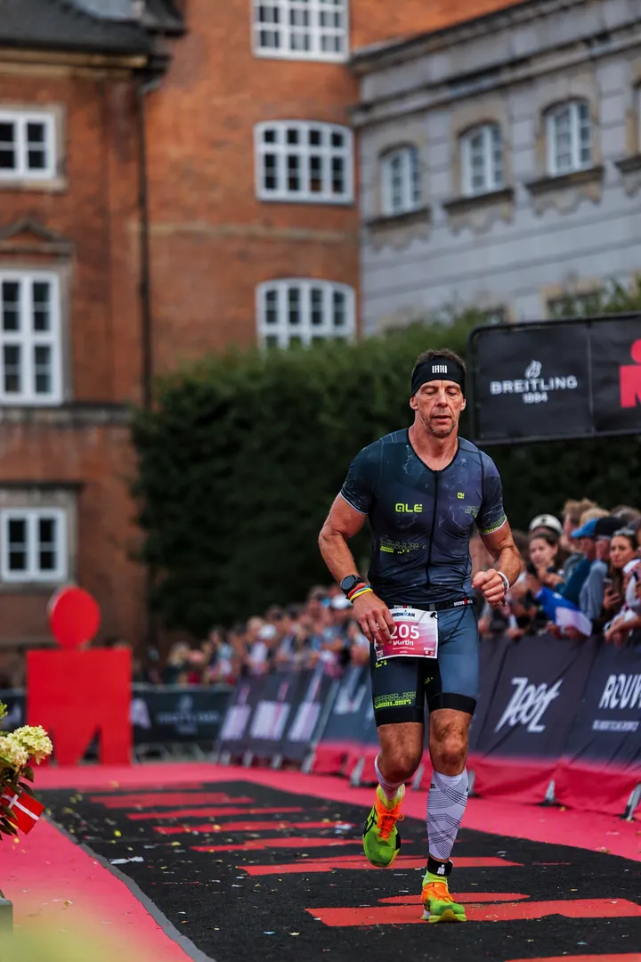 Martin running down the red carpet finishing chute at Ironman Copenhagen, eighteen months after hip resurfacing
