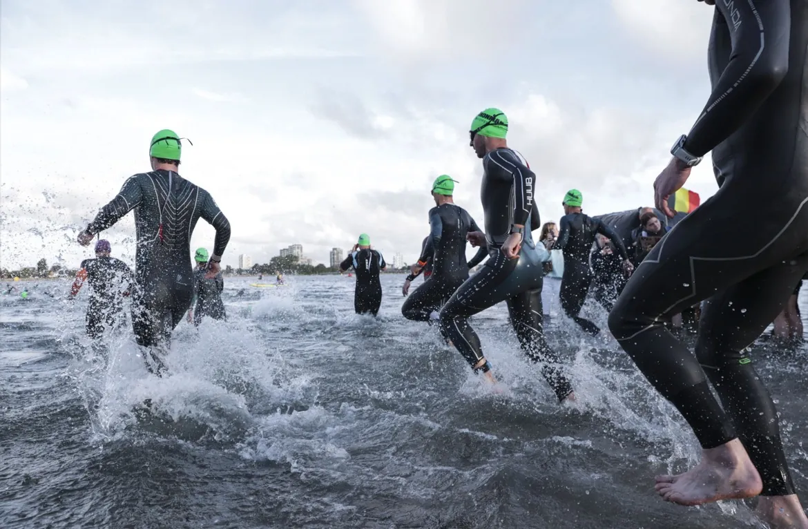Triathletes running into open water at the Ironman Copenhagen swim start, where Mr Hussain's hip resurfacing patient Martin raced